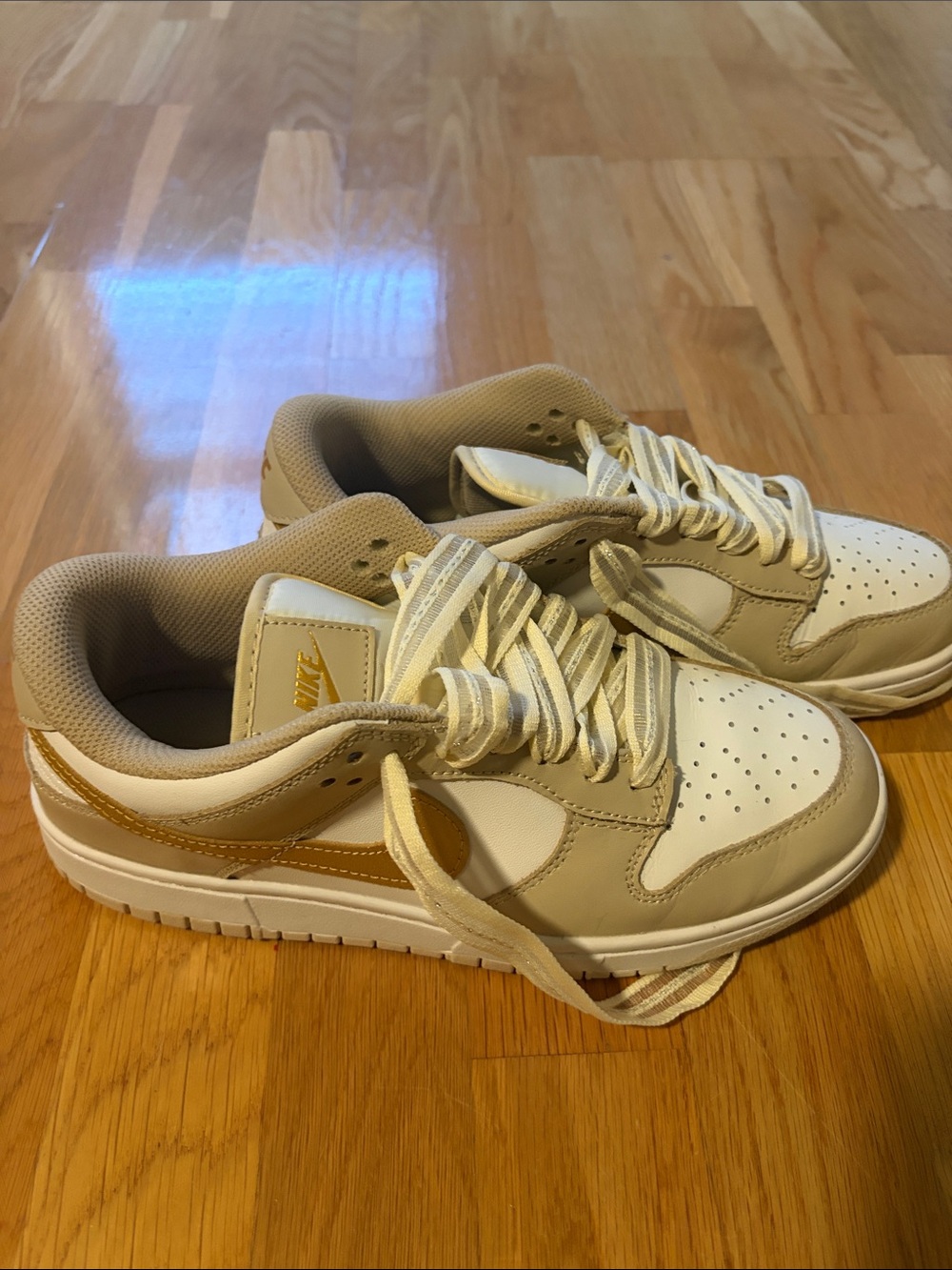 Nike Women’s Low-Top Sneakers in Beige and White with Gold Swoosh